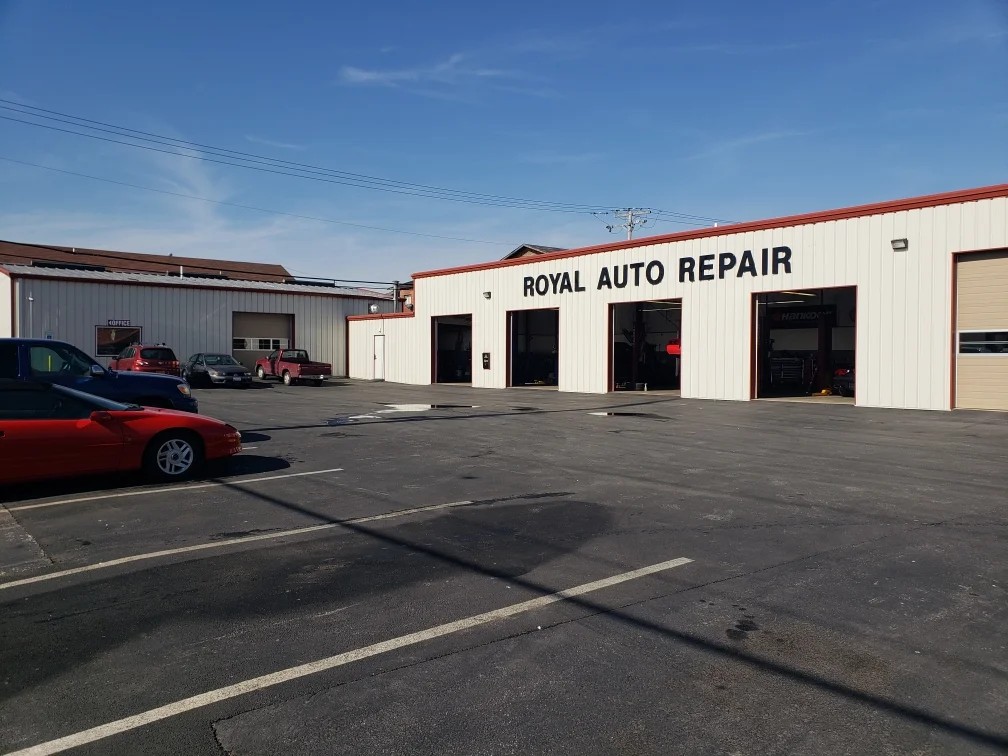 Mechanic working under hood at Royal Auto Repair