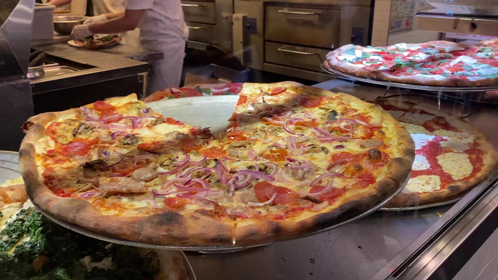 Fresh pizza slices at Joe's Pizza counter